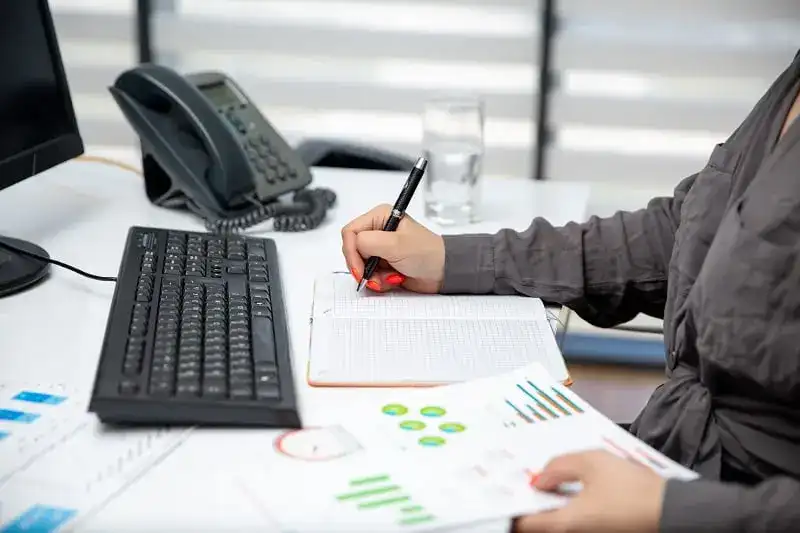 Internal Audit: Importance and Best Practices 6 front view young beautiful businesswoman working her pc table along with phone graphics writing down notes job activities technology