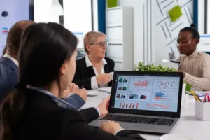 young woman analysing charts laptop start up business meeting room